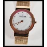 A ladies decorative yellow stainless steel Skagen - Denmark dress watch. Having a mother of pearl