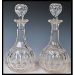 Two 20th Century cut lead glass decanters each faceted stoppers above faceted neck and body with cut