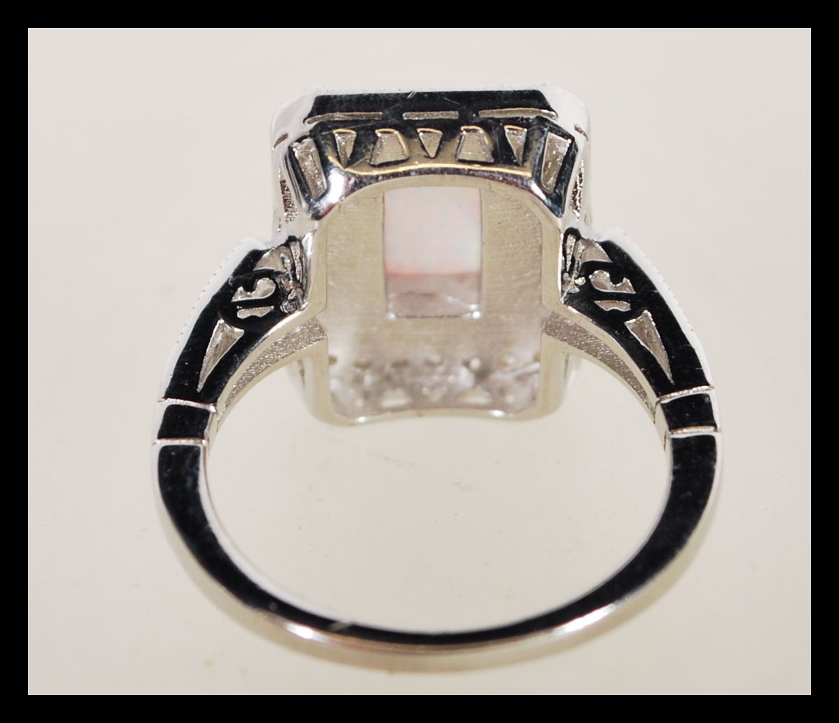 A sterling silver Art Deco style ring having a central opal panel and decorated with CZ stones. - Image 4 of 4