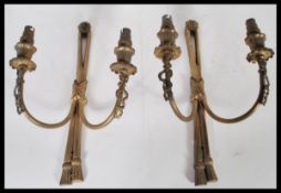 A pair of early 20th Century gilt brass Adams revival wall sconces having ormolu decoration with