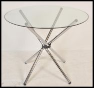 A contemporary chrome and glass coffee table / occasional table of atomic / sputnik form being in