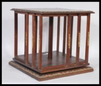 An early 20th Century Edwardian mahogany table top revolving bookcase, open slatted sides with