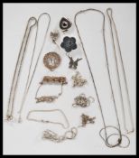 A selection of silver necklaces and pendants to include a heart locket, scarab beetle, butterfly,