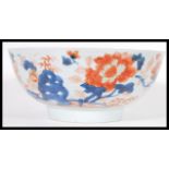An 18th Century Chinese Imari pattern centerpiece bowl having hand gilded decoration with central