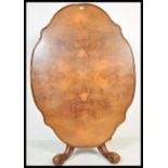 A 19th century High Victorian walnut tilt top breakfast loo table - dining table. Raised on shaped