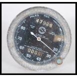 A Jaeger 80mph flanged speedometer having a black face with white hands. 9.5cm diameter.