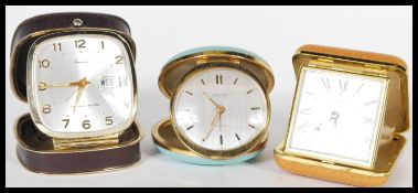 A collection of three vintage 20th Century travelling folding alarm clocks to include an example