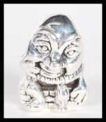 A sterling silver figurine pincushion in the form of humpty dumpty. Weighs 13 grams.