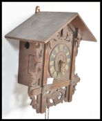 An early 20th Century Black Forest type wooden cuckoo clock having acorn weights with scrolled