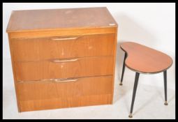 A retro 20th Century teak wood chest of three straight drawers together with a kidney shaped