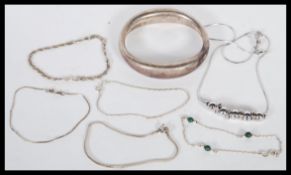 A collection of silver bracelets, to include a chunky bangle, silver necklace with ball and rings