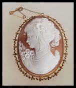 An early 20th Century Edwardian hallmarked 9ct gold and carved shell cameo brooch depicting a