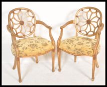 A pair of  cartwheel back Chippendale gilt mahogany dining chairs. Each with overstuffed seats