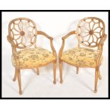 A pair of  cartwheel back Chippendale gilt mahogany dining chairs. Each with overstuffed seats