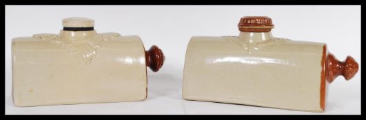A pair of 19th Century Victorian his and hers stoneware salt glazed bed warmers having coloured