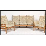 A 20th century Ercol Renaissance beech and elm wood three [iece suite to include the settee and