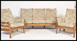 A 20th century Ercol Renaissance beech and elm wood three [iece suite to include the settee and