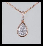 An 18ct rose gold and diamond cluster pendant and necklace set having approx 20pts of diamonds.