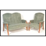 A retro 20th Century two piece suite consisting of a two seater sofa settee with a teak wood open