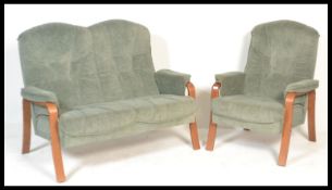 A retro 20th Century two piece suite consisting of a two seater sofa settee with a teak wood open