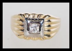 A 18ct gold and diamond signet ring having a central diamond of approx 33pts. Unmarked but tests