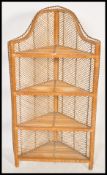 An early 20th century rattan weave ebony lined corner whatnot / etagere having 4 shelves with an