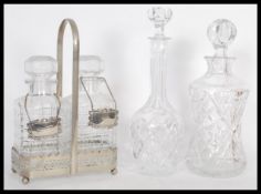 A group of 20th Century English glass decanters to include a decanter set tantalus in silver