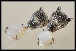 A pair of sterling silver and marcasite decorated designer earrings in the form of panthers having