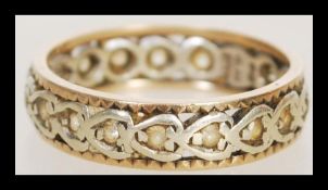 A hallmarked 9ct gold eternity ring of celtic influence set with white stones. Hallmarked