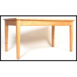 A 20th century antique style pine farmhouse dining table of rectangular form with thick plank top,