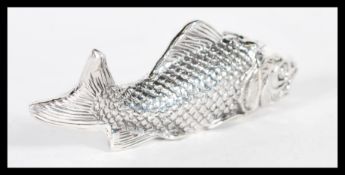 A sterling silver vesta case in the form of a fish having hinged lid to head. Weighs 50 grams.