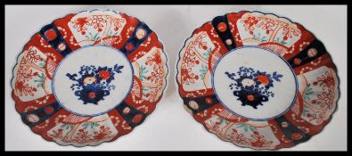 A pair of 19th Century Chinese plates of scalloped form, central panel decorated with potted peonies