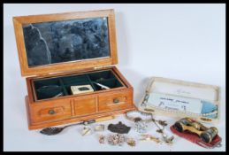 A collection of vintage costume jewellery to include brooches, a silver mourning brooch, bug brooch,