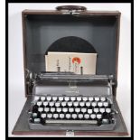 A vintage mid 20th Century Imperial portable typewriter complete in its original carry case.