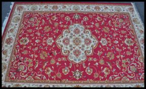 A 20th Century Bokhara Persian Islamic rug having a beige ground with red geometric patterned