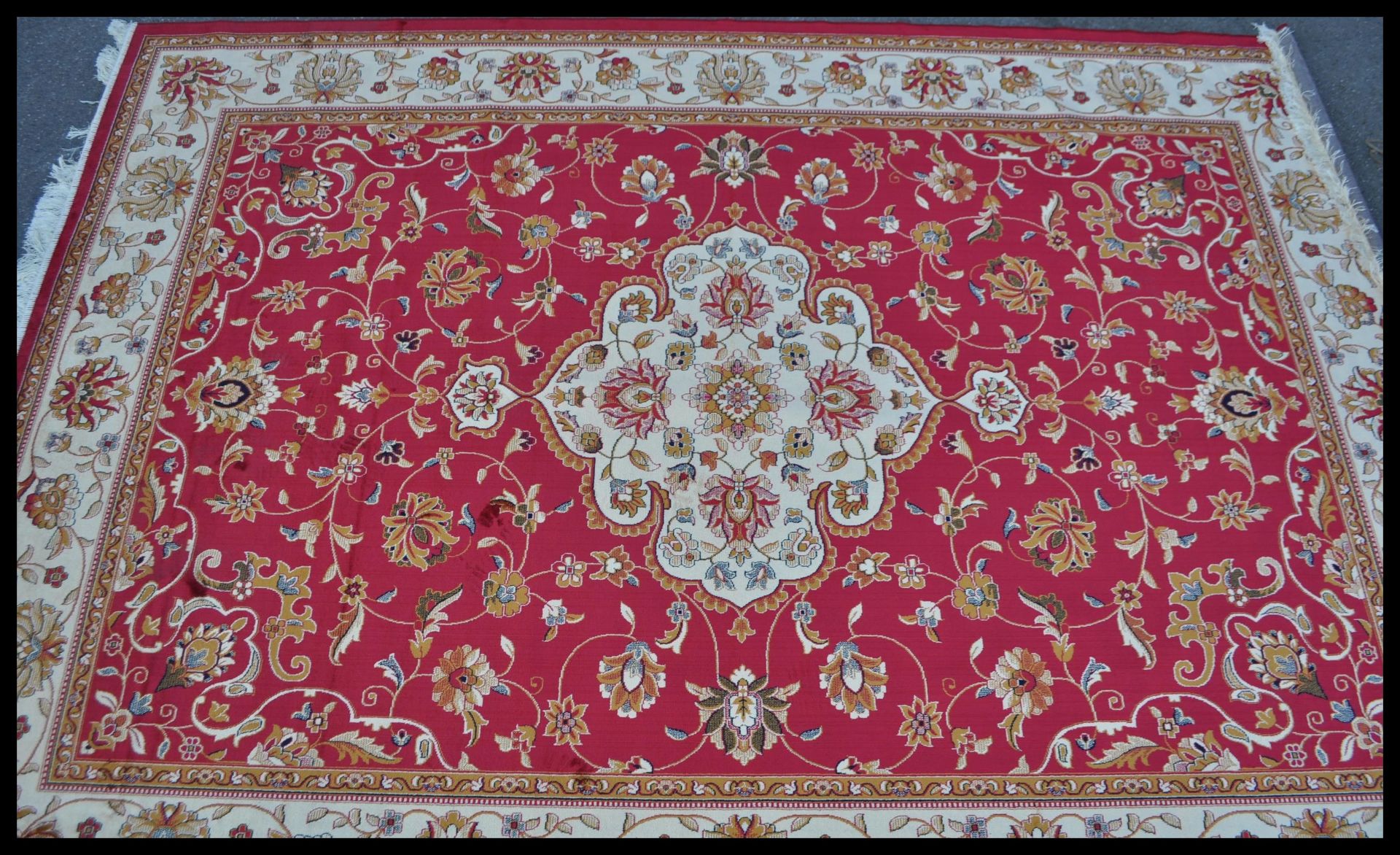 A 20th Century Bokhara Persian Islamic rug having a beige ground with red geometric patterned