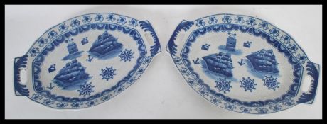A pair of blue and white twin handled trays, the trays decorated with a nautical theme depicting