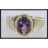 An 19th Century Victorian gold plated amethyst paste set buckle bracelet, chase decorated with