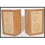 A pair of vintage retro 20th Century teak wood cased Sanyo hi fi speakers in a wooden teak casing.