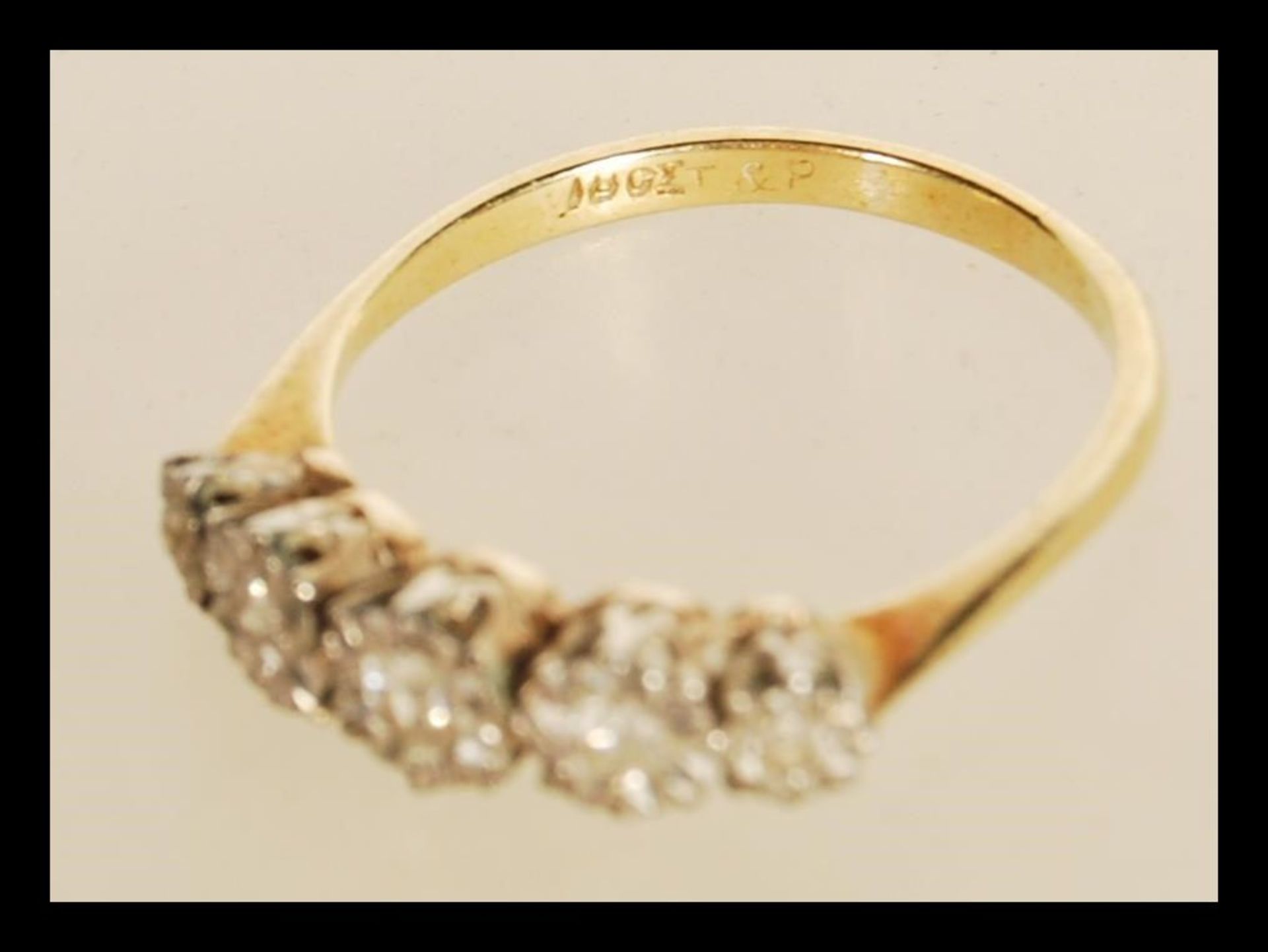 A stamped 18ct gold ring illusion set with five old cut diamonds. Weight 2.5g. Size O. - Bild 4 aus 4