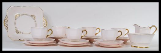 A 20th Century Tuscan fine English bone china tea service having gilded handles. Consisting of large