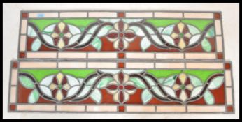 A pair of early 20th Century Edwardian rectangular lead glass window panels, central flower