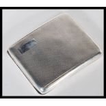 An early 20th Century hallmarked silver cigarette case by Joseph Rogers. The case of curved