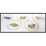 A group of five vintage retro 20th Century Washington Pottery vibrant decorated plates from the