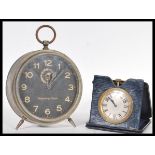 A vintage early 20th Century brass travel car pocket watch clock in folding leather case along