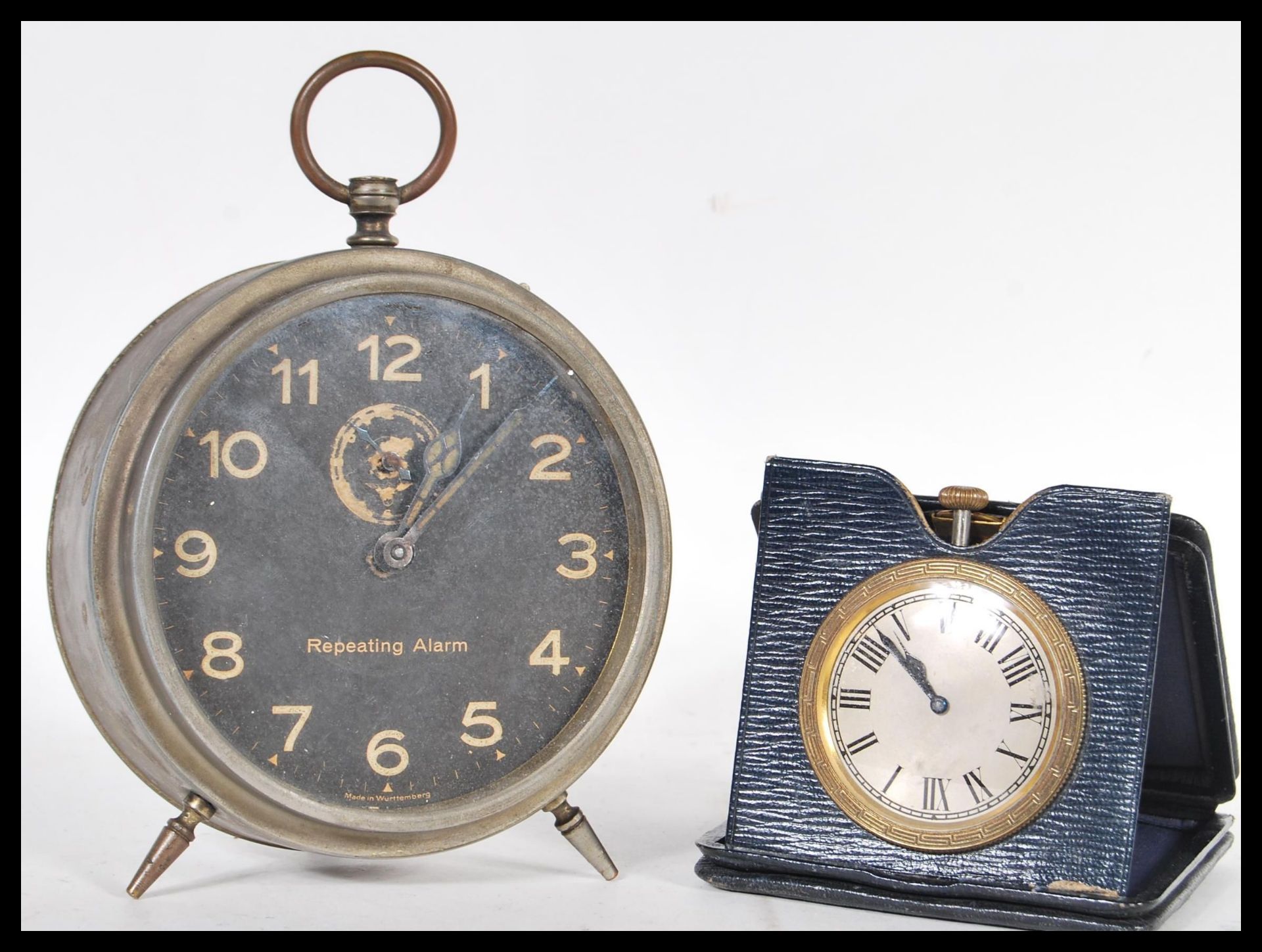 A vintage early 20th Century brass travel car pocket watch clock in folding leather case along