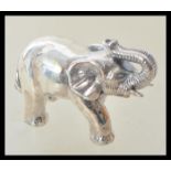 A sterling silver miniature figurine of an elephant. Weight 18.4g. Measures 2.5cm high.