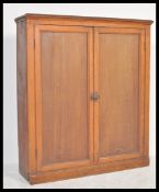 A 19th Century Victorian stained Industrial pine school cupboard, twin panelled doors fitted with