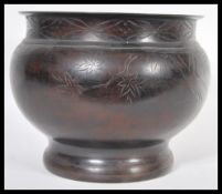 A 19th Century Japanese Meiji period bronze planter jardiniere of bulbous form having engraved