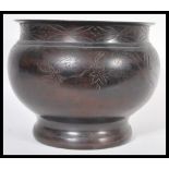 A 19th Century Japanese Meiji period bronze planter jardiniere of bulbous form having engraved